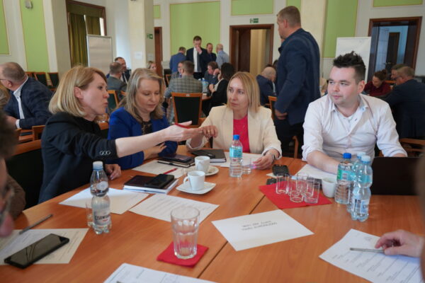 Uczestnicy warsztatów kreatywnych młodych rzemieślników — praca zespołowa przy stole